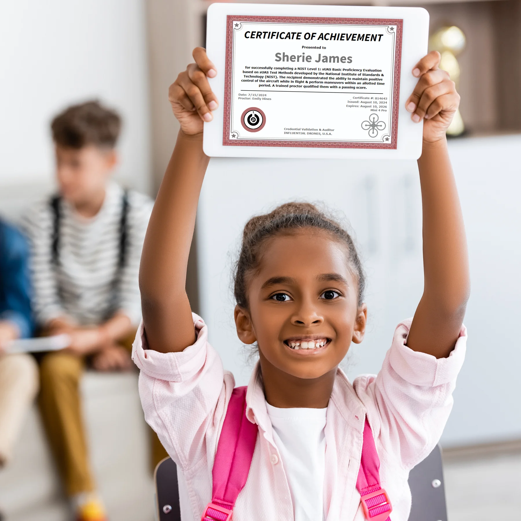 Student holding a tablet showing a sample certificate of achievement